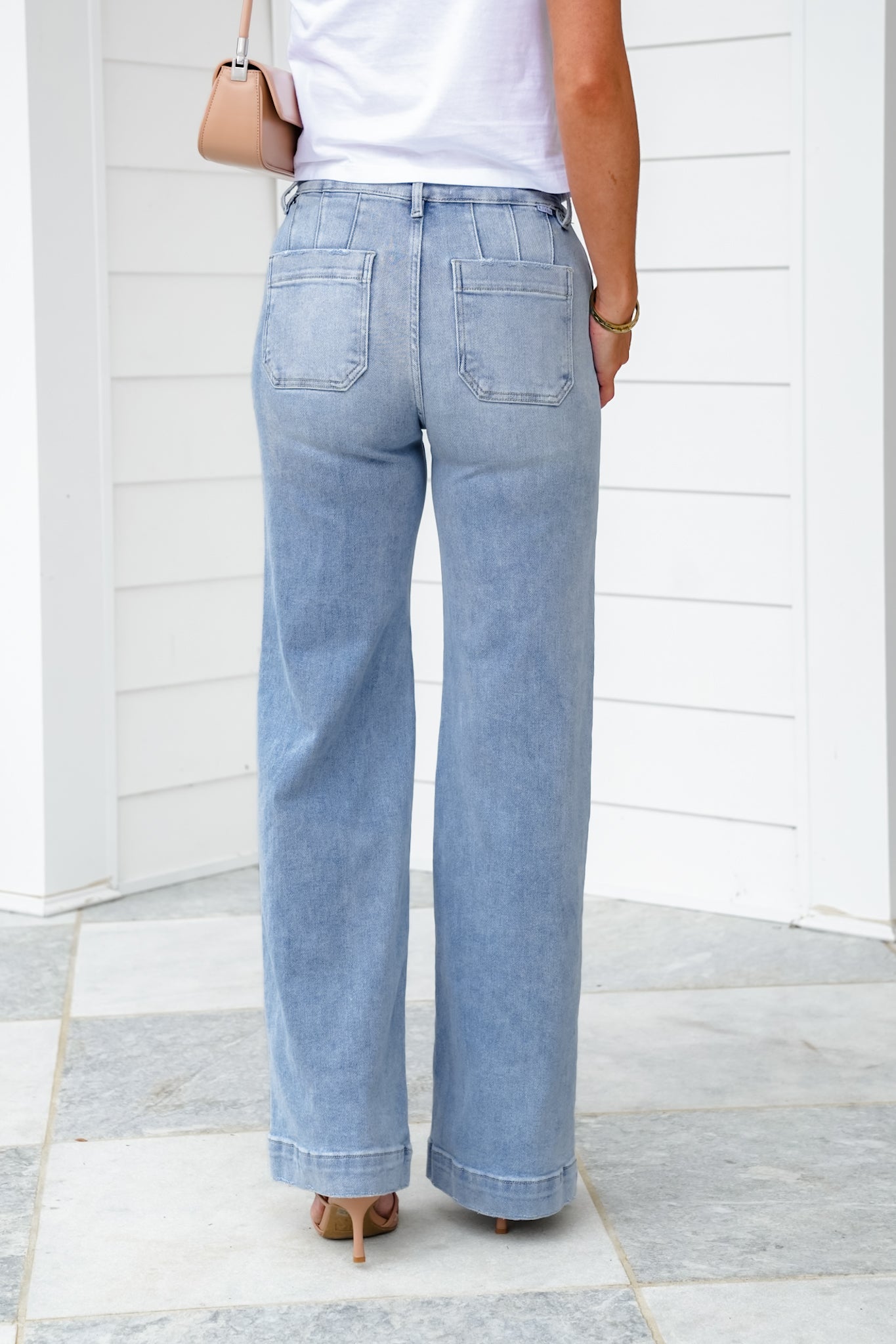 Risen High Rise Light Wash Wide Leg Jeans with Slanted Pockets