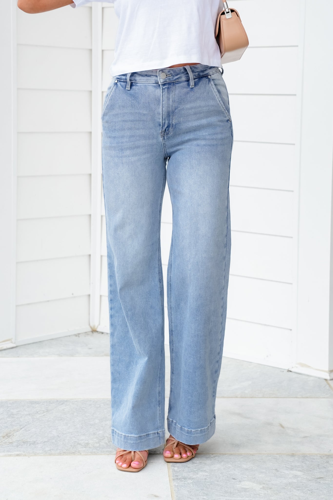 Risen High Rise Light Wash Wide Leg Jeans with Slanted Pockets