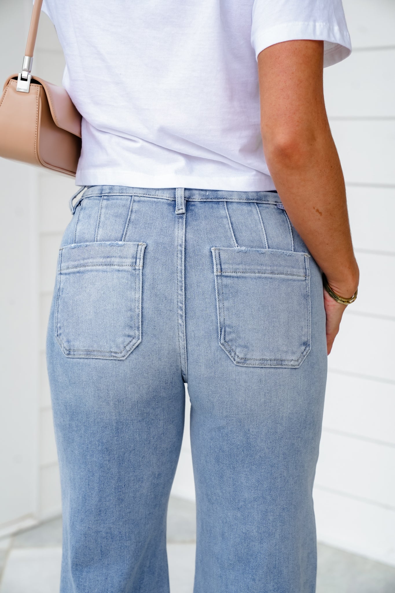 Risen High Rise Light Wash Wide Leg Jeans with Slanted Pockets