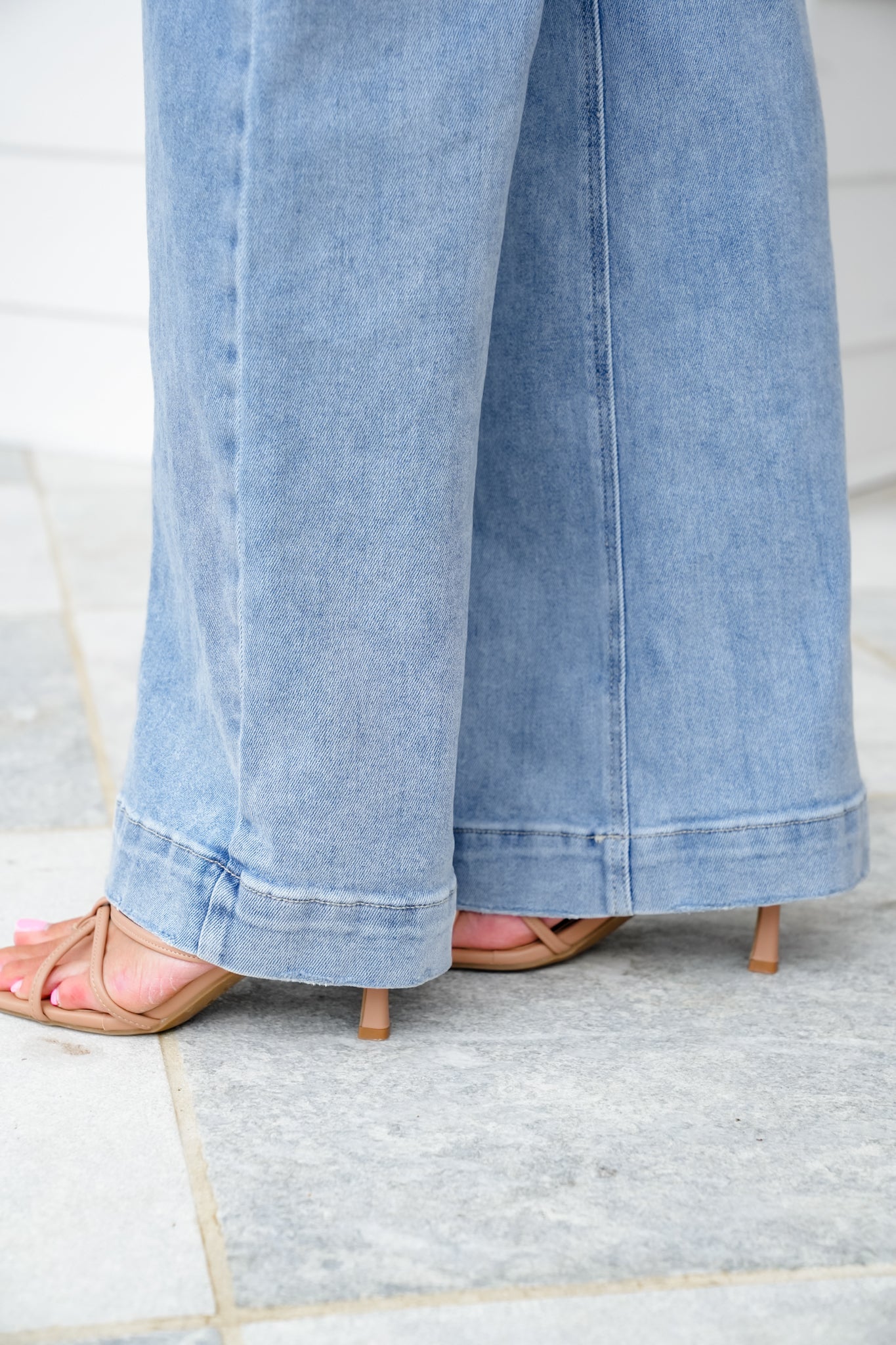 Risen High Rise Light Wash Wide Leg Jeans with Slanted Pockets