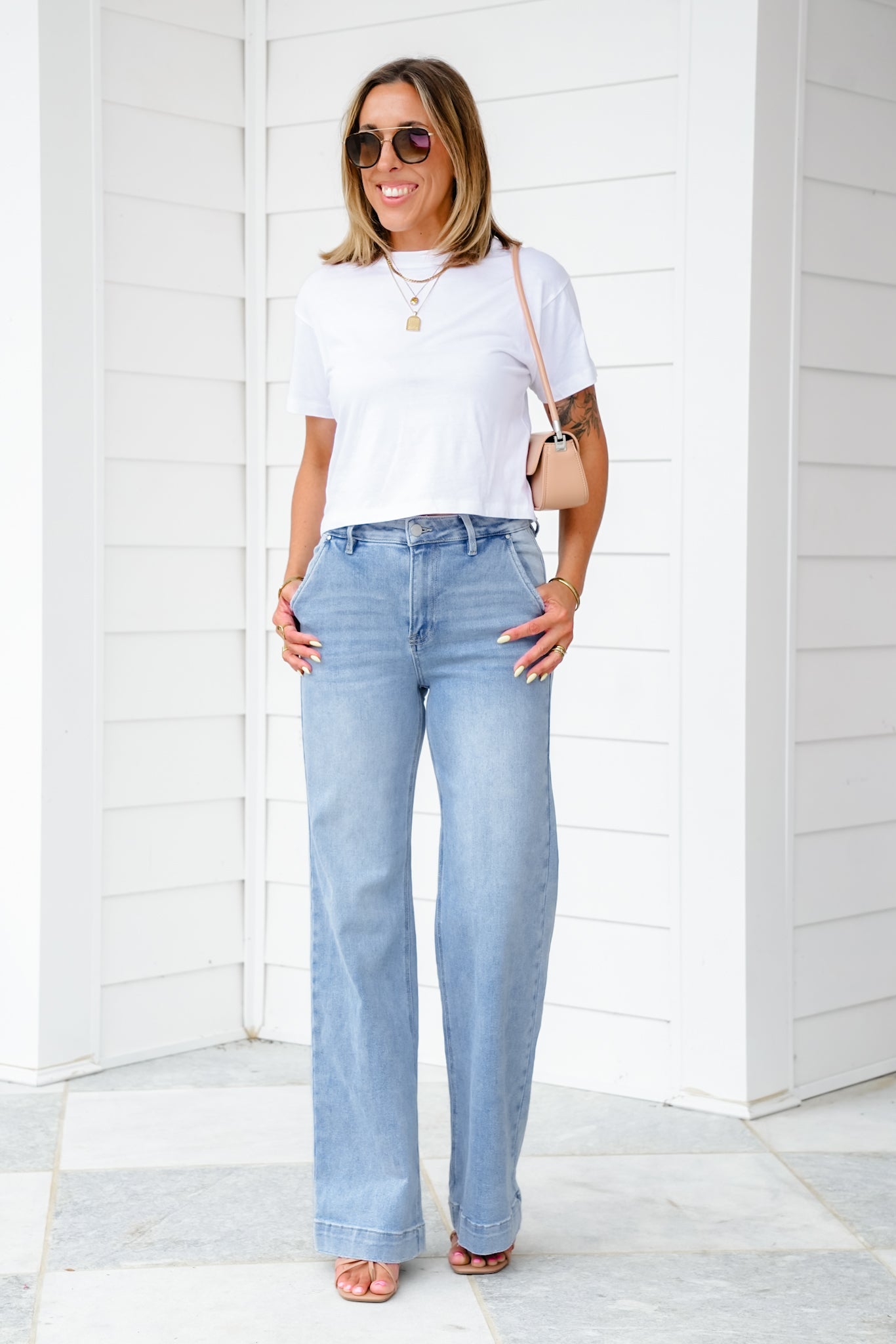 Risen High Rise Light Wash Wide Leg Jeans with Slanted Pockets