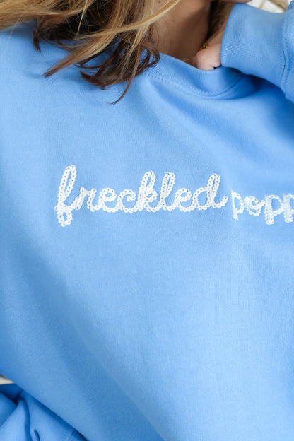 Plus/Reg Long Sleeve Embroidered "Freckled Poppy" Graphic Sweatshirt