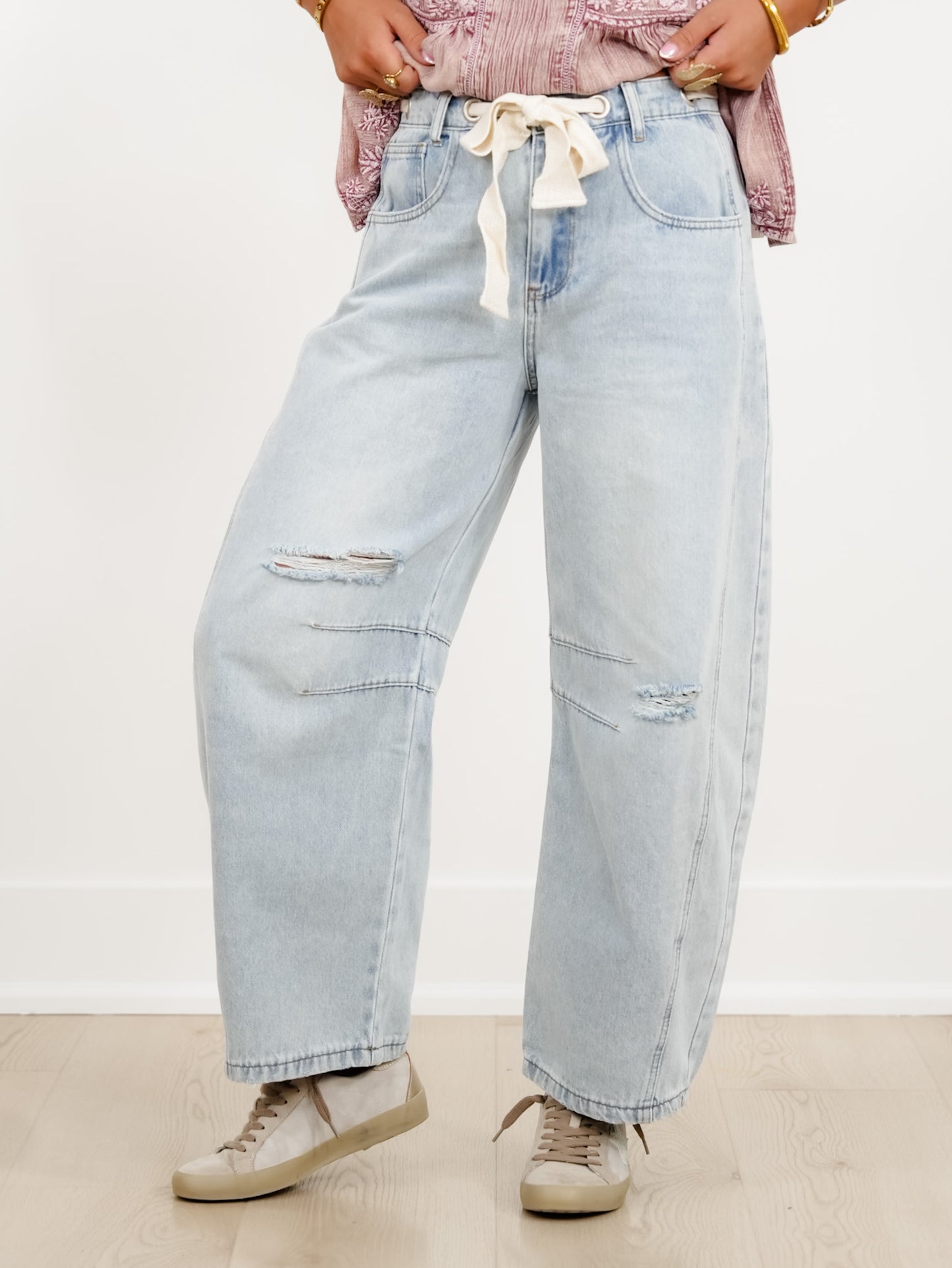 Distressed Light Wash Barrel Jeans with Eyelet Belt